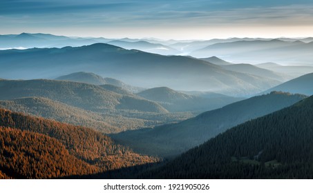 Awesome alpine highland in sunny misty morning. Wonderful Autumn landscape with mountain layers. Mountain valley Scenery during sunrise.  Stunning nature background. Artistic image wallpaper
