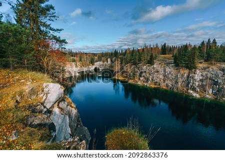 Awesome autumn landscape. Marble quarry in Ruskeala Mountain Park,Karelia. View of the rocks and the emerald water of the Marble Canyon. Now these deep quarries  serve as a popular tourist attraction.