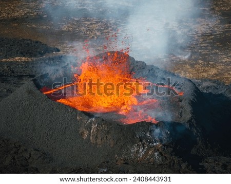 Awesome close up view of boiling red lava lake inside the active volcano crater, drone top down shot. Living volcano and eruption concepts.
