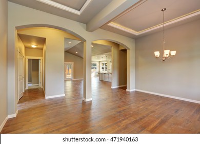 Awesome Entrance Hall Of Brand New House. Empty Entryway With Coffered Ceiling, Arches And Kitchen Room At The Back. Northwest, USA