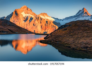 Awesome evening panorama of Bachalp lake (Bachalpsee), Switzerland. Unbelievable autumn sunset in Swiss Alps, Grindelwald, Bernese Oberland, Europe. Beauty of nature concept background. - Powered by Shutterstock