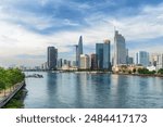 Awesome Ho Chi Minh City skyline. Amazing view of skyscrapers and other high-rise buildings reflected in water of the Saigon River at downtown of Ho Chi Minh City, Vietnam. Scenic cityscape.