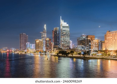 Awesome Ho Chi Minh City skyline. Night view of skyscrapers and other high-rise buildings at downtown of Ho Chi Minh City, Vietnam. Colorful city lights reflected in water of the Saigon River. - Powered by Shutterstock