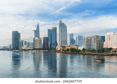 Awesome Ho Chi Minh City skyline. Boats are crossing the Saigon River. Amazing view of skyscrapers and other high-rise buildings reflected in water at downtown of Ho Chi Minh City, Vietnam. - Powered by Shutterstock