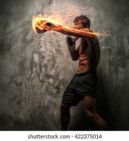 Awesome male with great body antomy fire boxing. Grey background.