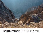Awesome mountain view from cliff at very high altitude. Scenic landscape with beautiful sharp rocks near precipice and couloirs in sunlight. Beautiful mountain scenery on abyss edge with sharp stones.
