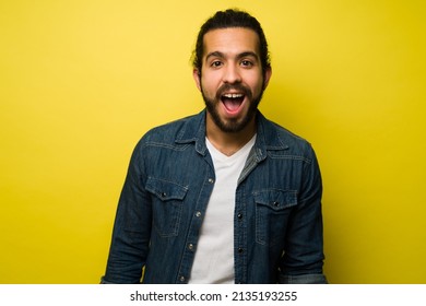 Awesome Portrait Of An Excited Hispanic Man Screaming After Receiving Good Amazing News