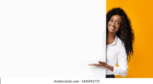 Awesome Promo. Smiling African American Woman Presenting Something On White Blank Board With Empty Space, Panorama