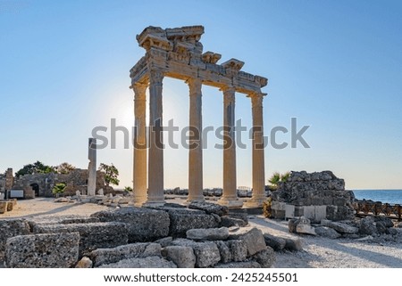 Awesome ruins of the Temple of Apollo on the Mediterranean Sea coast in Side, Turkey. The Roman temple is a popular tourist attraction in Turkey. Amazing view of columns on sunny day.