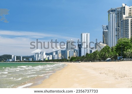Awesome view of central beach of Nha Trang, Vietnam. Beautiful white sand tropical beach in coastal city. Scenic coastline. Amazing cityscape. Nha Trang is a popular tourist destination of Asia.
