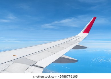 Awesome view of the Earth under the airplane wing. Amazing landscape is visible through airplane window. Traveling by plane. Flying in the sky among clouds. - Powered by Shutterstock