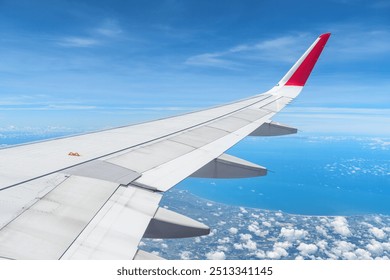 Awesome view of the Earth under the airplane wing. Amazing landscape is visible through airplane window. Traveling by plane. Flying in the sky among clouds. - Powered by Shutterstock