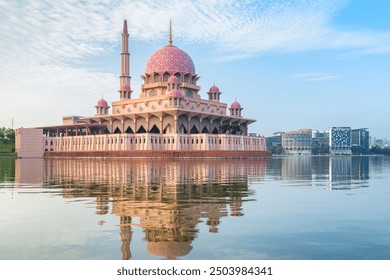 Awesome view of the Putra Mosque at sunrise, Putrajaya, Malaysia. The pink dome and minaret are reflected in water of the Putrajaya Lake. The mosque is a popular tourist attraction of Asia. - Powered by Shutterstock