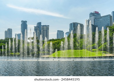 Awesome view of scenic fountains in a green urban park of Kuala Lumpur, Malaysia. Amazing Kuala Lumpur skyline. Wonderful cityscape. Kuala Lumpur is a popular tourist destination of Asia. - Powered by Shutterstock