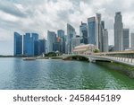 Awesome view of skyscrapers at downtown across Marina Bay in Singapore. High-rise buildings reflected in water. Amazing Singapore skyline. Singapore is a popular tourist destination of Asia.