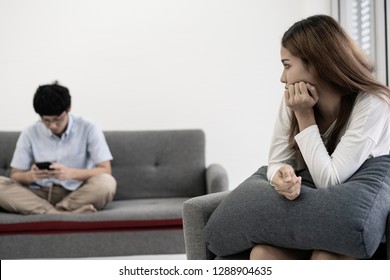 Awkward Couple, Issues In Family Concept. Sad Woman On Sofa Feeling Bad With Her Love Partner.