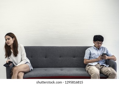 Awkward Couple, Issues In Family Concept. Sad Woman On Sofa Feeling Bad With Her Love Partner.