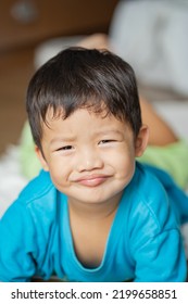 An Awkward Smile Of A Toddler On His Photographer