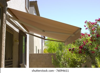 Awning Above Back Yard Door To Residential Two-storied House