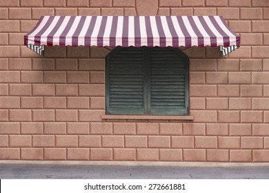 Awning Over Wooden Window On Brick Wall