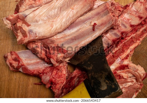 The ax is cut into the meat. Dividing pork\
with an ax. Pork\
production.