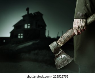 Axe With Blood In Male Hand.  Murderer Or Butcher Looking On A Night House, Halloween Theme