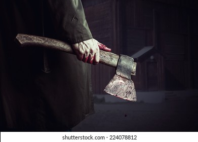 Axe With Blood In Male Hand.  Murderer Or Butcher, Halloween Theme