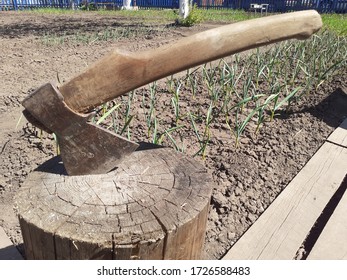 An axe driven into a wooden block. Wooden axe handle. - Shutterstock ID 1726588483
