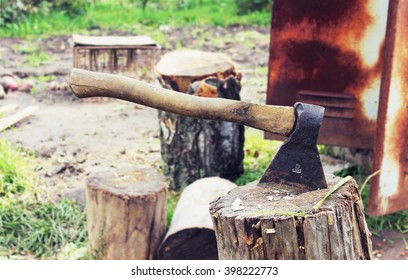 An axe on a stump in the garden