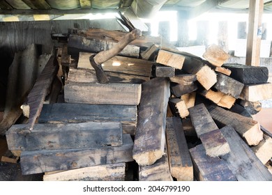 Axe and pile of firewood under the canopy