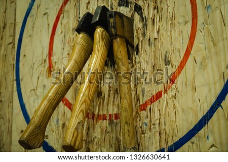 Axe stick in to the wood bull's eye in throwing axe sport
