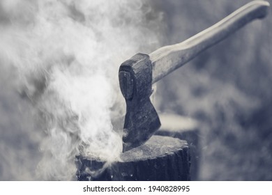 Axe In Tree Stump And Smoke From Campfire. Black And White Retro Toned Image.