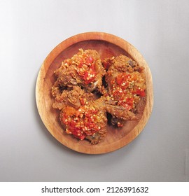 Ayam geprek is a typical Indonesian food made from crispy fried chicken pressed with sliced ​​chili

                        