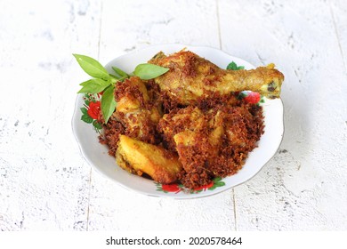 Ayam goreng lengkuas or ayam goreng bumbu kuning is a traditional indonesian fried chicken. Served on white plate. Hotizontal top view. Isolated