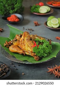 ayam goreng ungkep rempah or traditional javanese fried chicken. full of spicies, close up, served on black plate