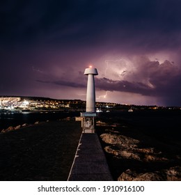 Ayia Napa Sea Lighthouse Lighthouse At Night During A Thunderstorm.