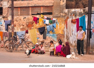 AYODHYA, INDIA - JAN 27: Unidentified children of poor family play outdoor near the village house with drying clothes on January 27 2013. Ayodhya with a population of 49,593 is birthplace of Lord Rama