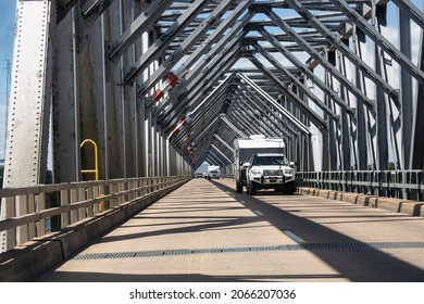 Ayr, Queensland, Australia - 13 September 2020; A girder truss bridge over the Burdekin River at Ayr, Queensland, Australia, with holiday traffic vehicles.