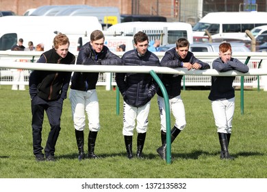 AYR RACECOURSE, AYRSHIRE, SCOTLAND, UK : 13 APRIL 2019 : A Group Of 5 Young Conditional Jockeys Lean On The Rails Near The Last Fence Whilst They Watch The Scottish Grand National