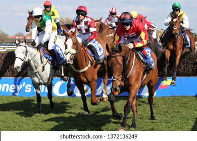 AYR RACECOURSE, AYRSHIRE, SCOTLAND, UK : 13 APRIL 2019 : The Horses Jump The Last Fence On The First Circuit Of The Scottish Grand National Led By Vintage Clouds, Geronimo And Cogry