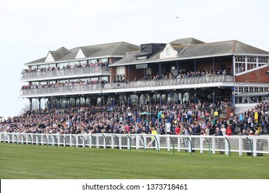 AYR RACECOURSE, AYRSHIRE, SCOTLAND, UK : 12 APRIL 2019 : The Crowd In The Packed Grandstand At Ayr Racecourse