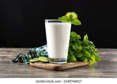 Ayran drink with mint and cucumber in glass on wooden table - Shutterstock ID 2149744017