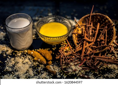 Ayurvedic Blood Purifier And Skin Glow Face Mask Consisting Of Manjistha, Mung Bean, Haldi/turmeric, And Milk. Horizontal Shot Of Face Mask With Entire Constituents With It On A Black Surface.