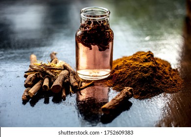 Ayurvedic DIY Piles Cream Consisting Of Revand Chini Root Powder Well Mixed With Rose Water. Shot Of Revand Chini Powder Along With Some Fresh Organic Rose Water In A Glass Bottle.