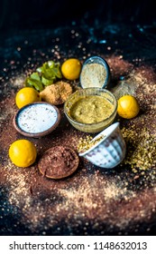 Ayurvedic Face Pack Or Ubtan Of Moong Dal Or Green Lentil Or Mung Dal With Lemon,dried Orange Peel Powder,chandan Powder Or Sandal Wood Powder,milk And Aloe Vera Gel On Wooden Surface.