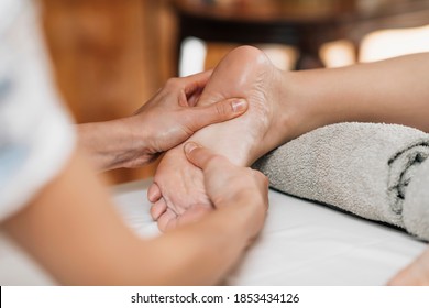 Ayurvedic Foot Massage. Ayurveda Practitioner Pressing Meridian Points On Female Foot