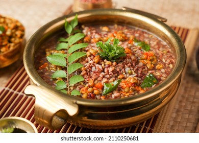 Ayurvedic Porridge, Karkidaka Kanji Herbal Gruel In Clay Pot Black Background Kerala South India. Ayurveda Diet Health Drink For Immunity, Cleanse The Body. Top View Medicinal Porridge Indian Veg Food