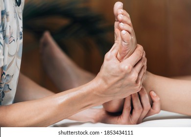 Ayurvedic Reflexology Foot Massage, Ayurveda Practitioner Pressing Meridian Points On Female Foot.