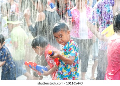 AYUTTAYA,THAILAND-APRIL 13: unidentified People celebrating Songkran (Thai new year / water festival) child and his water gun on road April 13, 2012 in Ayuttaya, Thailand.