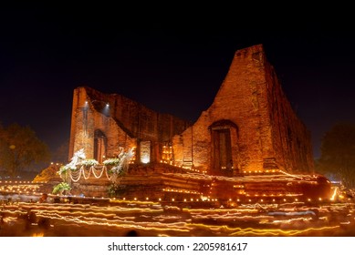 Ayutthaya - 19 February 2019 During The Evening Time At A Temple In Ayutthaya. People Come To Walk Around The Church With Candles. To Remember The Buddha By Walking On The Right Side Of The Church